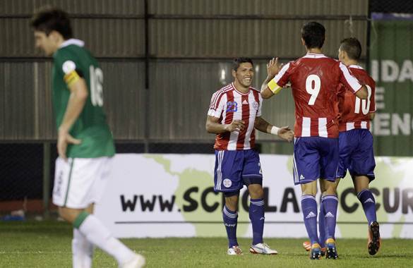 Paraguay's Richard Ortiz celebrates with teammates after scoring against Bolivia in their 2014 World Cup qualifying soccer match in Asuncion